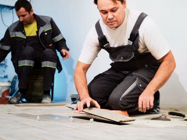 installing-ceramic-floor-tiles-construction-site-construction-workers-workers-laying-tiles-floor-with-cement-adhesive-renovating-floor (1)